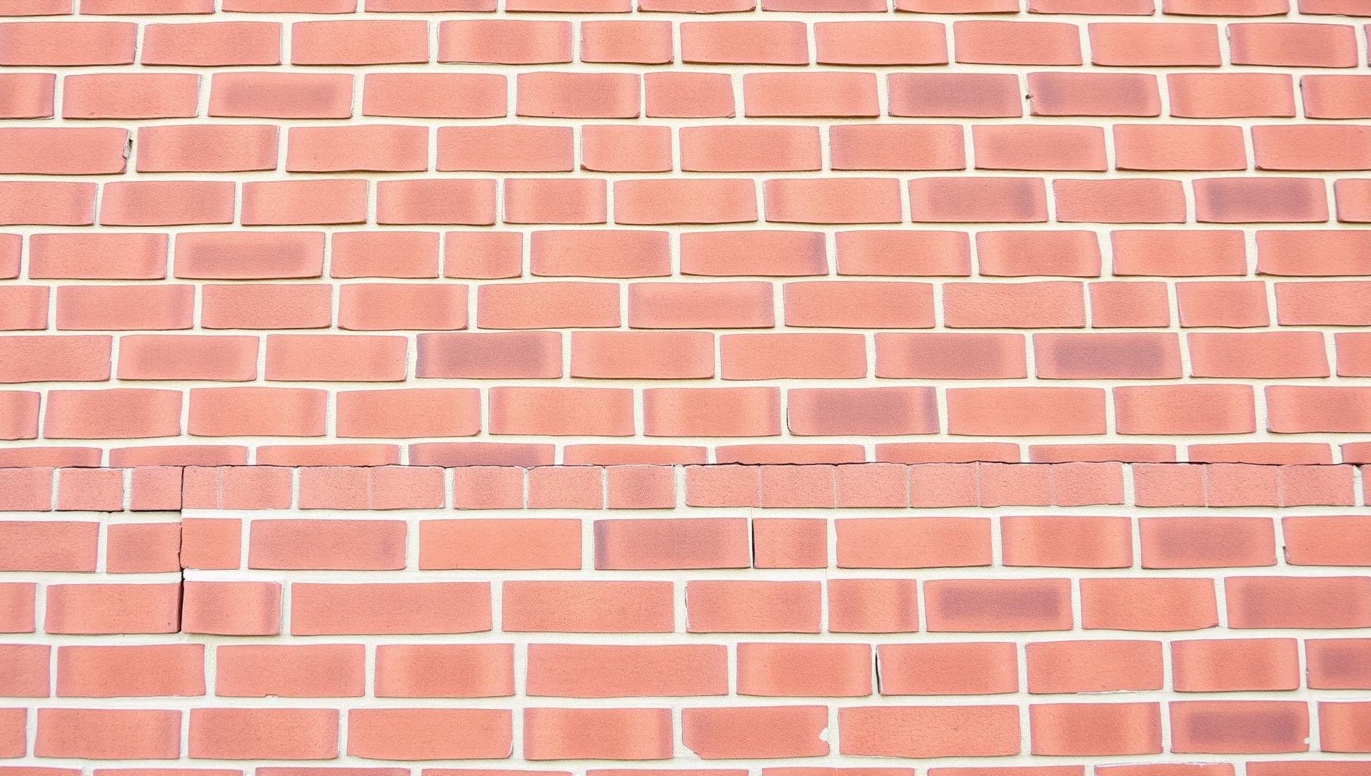 Evenly tinted red-brown brick wall blending replacement bricks with existing brickwork — professional brick tinting and colour matching