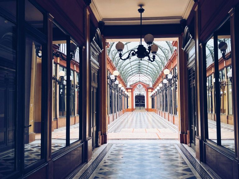 a picture of a row of shops fronts in a covered archway